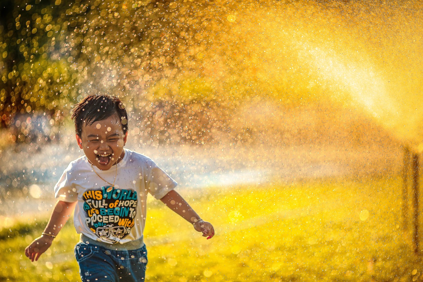 a_young_boy_running_through_a_sprinkle_of_water - ©phammi