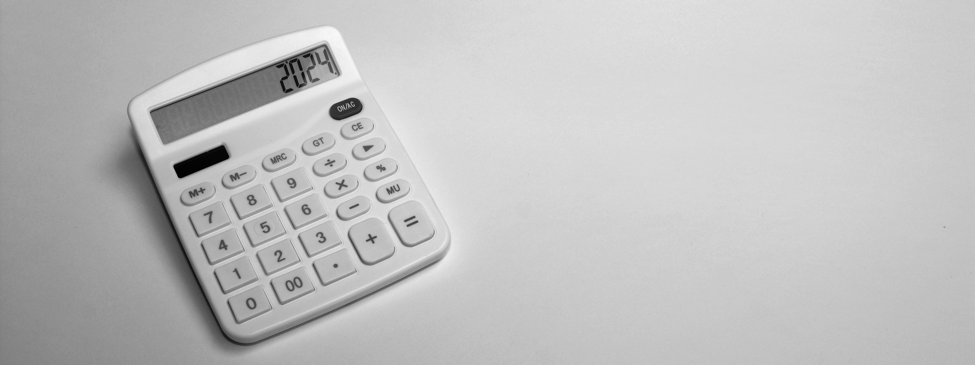 a_white_calculator_sitting_on_top_of_a_table - ©shift14